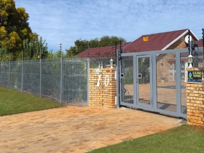 Clear View fencing and secure access gate installation at a residential property in South Africa, providing high-security perimeter protection.