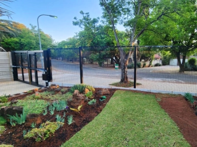 Sliding security gate and Clear View fencing protecting a residential entrance, combining access control with long-lasting perimeter security.